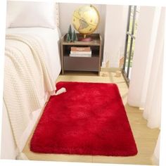 a red rug on the floor in a bedroom