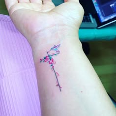 a small tattoo on the wrist of a woman