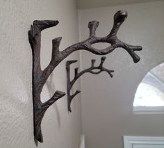 two metal branches are hanging on the wall