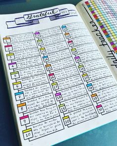 an open planner with colorful lines on it