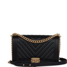 a black chanel bag with gold hardwares on the front and shoulder strap,