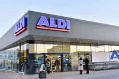 an aldi store with people standing outside