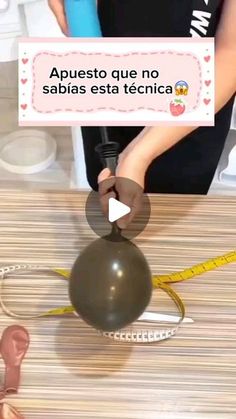 a person is doing something on top of a ball with a measuring tape in front of it