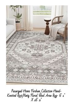 a large rug with an ornate design in grey and white colors is featured on a living room floor