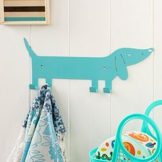 there is a towel rack on the wall with a blue dog hanging from it's side