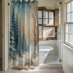 a bathroom with a shower curtain that has trees on it and a bathtub in the background