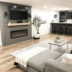 a living room with a couch, coffee table and fireplace