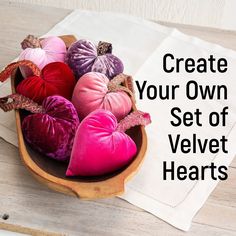 a wooden bowl filled with hearts on top of a table