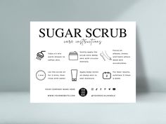 the sugar scrub poster is displayed on a table