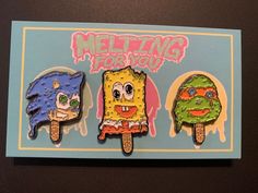 three cartoon ice cream pops are on a card