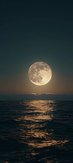 the moon is shining brightly over the water