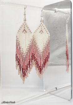 Elegant and fashionable gradient-color fringe earrings. Cream white and romantic raspberry pink. These earrings are lightweight and comfortable to wear, making them suitable for everyday wear or special occasions. They can add a touch of bohemian or tribal flair to any outfit and are often chosen as statement accessories to enhance a simple or minimalistic look. They are made using the brick stitch bead weaving technique and loose fringes of qualitative Japanese Toho 15/0 glass seed beads. The s Pink Beaded Fringe Earrings For Summer, Pink Bohemian Beaded Earrings, Pink Beaded Fringe Earrings For Beach, Summer Pink Beaded Fringe Earrings, Bohemian Pink Beaded Earrings With Fringe, Fish Hook Earrings, Beaded Dangle Earrings, Pink Earrings, Brick Stitch