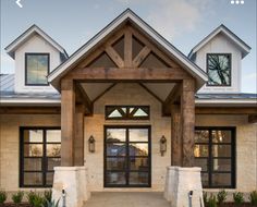 the front entrance to a home with large windows