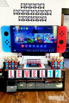 a video game themed birthday party with games on the wall and candy bar in front