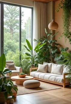 a living room filled with lots of plants and furniture next to large windows on either side of the wall