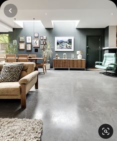 a living room filled with furniture and a skylight over the top of it's windows