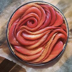 a bowl filled with red and orange yarn