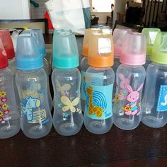 the baby bottles are lined up on the table