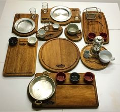 an assortment of wooden plates and silverware on a table