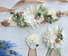 three ribbons with flowers on them hanging from the wall