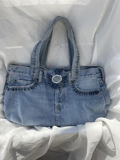 Stonewashed denim tote handbag purse upcycled w/rhinestone accented denim flower snap, and hemmed pockets White jersey interior w/ denim bottom and one denim pocket 3 front and 2 back exterior pockets Top handle 6.5'' strap drop 15 1/2" (L) x 10 1/2" (H) x 5" (D) wt. 10.5 oz. Flower Snap, Denim Flowers, Denim Pocket, Top Handle Bags, Denim Tote, White Jersey, Pocket Top, Tote Handbag, Handbag Purse