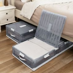 two suitcases sitting on the floor in front of a bed