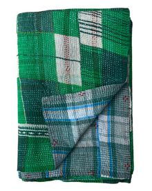 a green and white plaid blanket folded on top of each other