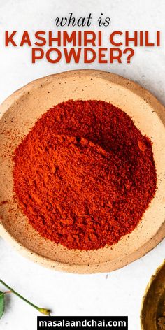 a bowl filled with red powder next to a spoon