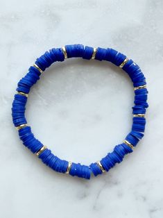 7’ bracelet. Royal blue clay and gold field beads. Cheap Blue Bracelets With Gold Beads, Cute Blue Bracelet Ideas, Blue Bangle Jewelry With Large Beads, Blue Beaded Bracelets With Gold Beads, Adjustable Blue Bracelets With Gold Beads, Blue Stretch Bracelet With Gold Round Beads, Adjustable Blue Jewelry With Gold Beads, Blue Stretch Bracelet With Gold Beads, Blue Spacer Beads Bangle Jewelry