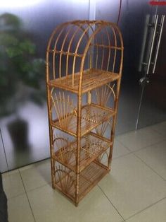 a bird cage sitting on top of a tiled floor