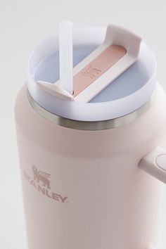 a pink coffee cup with a straw sticking out of it's top and lid