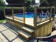 an above ground pool with steps leading up to it and a deck in the middle