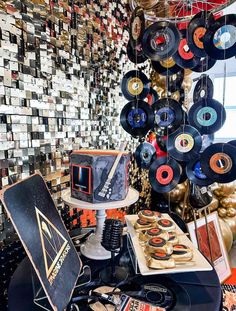 an assortment of records hanging from the ceiling in a room with many other items on display