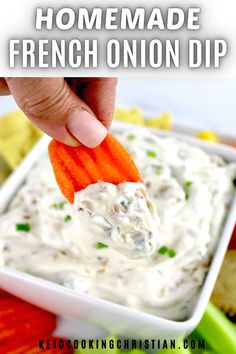 a hand dipping a carrot into a bowl of ranch dip