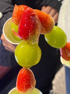 the fruit is being served in small cups