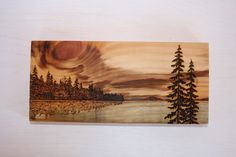 a painting on wood with trees and water in the background