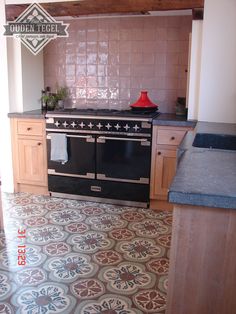 a black stove top oven sitting inside of a kitchen