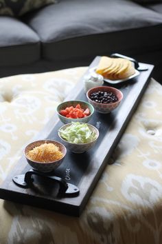 a tray that has some food on it and is sitting on top of a couch