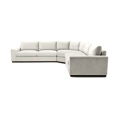 a white sectional couch sitting on top of a white floor