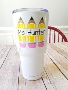 a white cup sitting on top of a wooden table