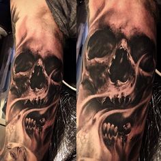 a man's arm with a skull tattoo on it