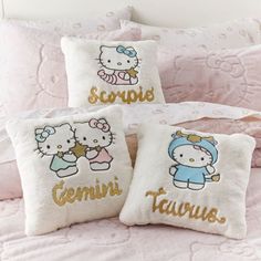 three pillows with hello kitty designs on them