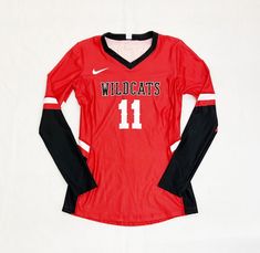 a women's red and black jersey with the number 11 on it, sitting against a white background