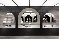 the interior of a book store with arches and bookshelves on display in front of them