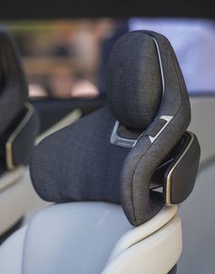 the interior of a car with an arm rest and headrest on it's back