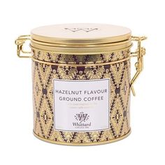 a gold canister with a label on the lid that says hazelnut flavor ground coffee