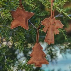 two leather christmas ornaments hanging from a tree