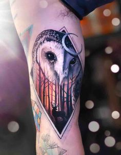 an owl tattoo on the leg with trees and animals in it's center, surrounded by dots