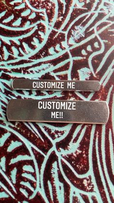 two metal tags that say customize me