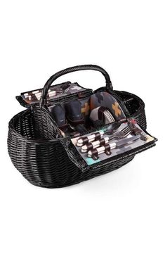 a black wicker basket filled with lots of different types of utensils in it